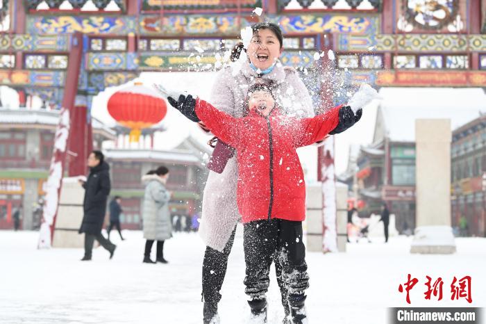2月13日，家長與小朋友在呼和浩特市大召廣場享雪趣?！⑽娜A 攝